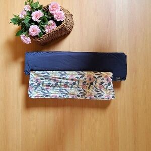 Milkmaid Goods Floral Changing Pad Cover and Navy Blue Swaddle Blanket.